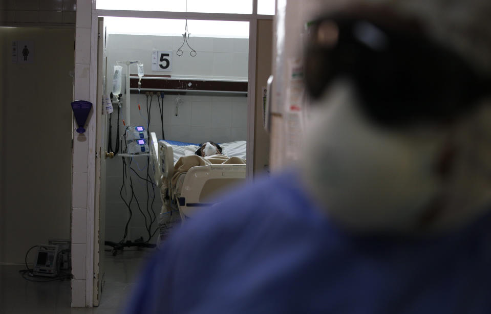 A COVID-19 patient lies on a bed of the Mexico City Ajusco Medio General Hospital ICU ward, Wednesday, Dec. 2. 2020. Mexico continues to report an increase in the number of coronavirus cases, with Mexico City continuing to report the biggest portion of the surge in cases. (AP Photo/Marco Ugarte)