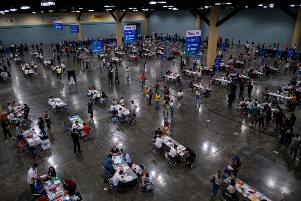 People attend the first mass vaccination event to get inoculated with the Johnson and Johnson Covid-19 vaccine at the Puerto Rico Convention Center in San Juan, Puerto Rico on March 31, 2021. (Ricardo Arduengo/AFP via Getty Images)