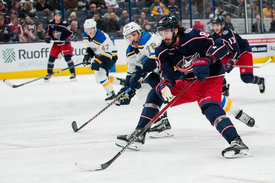 Dec 8, 2023; Columbus, Ohio, USA; Columbus Blue Jackets right wing Kirill Marchenko (86) brings the puck up ice past St. Louis Blues defenseman Justin Faulk (72) during the third period of the NHL game at Nationwide Arena. The Blue Jackets won 5-2.