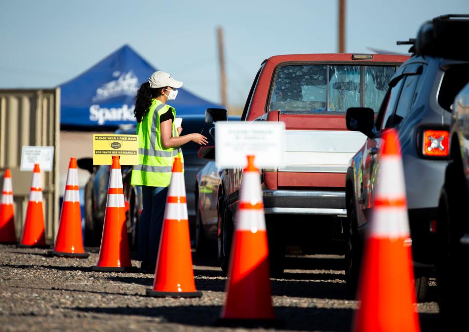 Contractors working with the United States Air Force distribute bottled water at a site near Luke Air Force Base in Glendale on Feb. 23, 2021. The water was being distributed to local residents after high levels of contaminants known as "forever chemicals" coming from the Air Force base were found in the community’s drinking water.