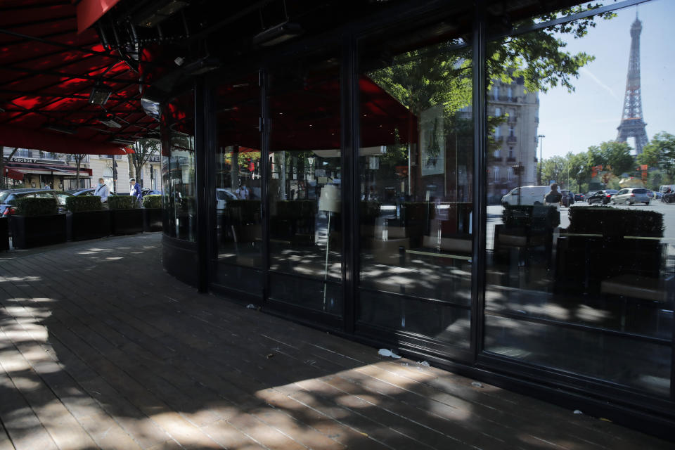 An empty terrace of a restaurant is pictured in Paris, Thursday, May 28, 2020. France is reopening its restaurants, bars and cafes starting next week as the country eases most restrictions amid the coronavirus crisis. Edouard Philippe defended the gradual lifting of lockdown up to now, saying the strategy was meant to avoid provoking a second wave. (AP Photo/Christophe Ena)