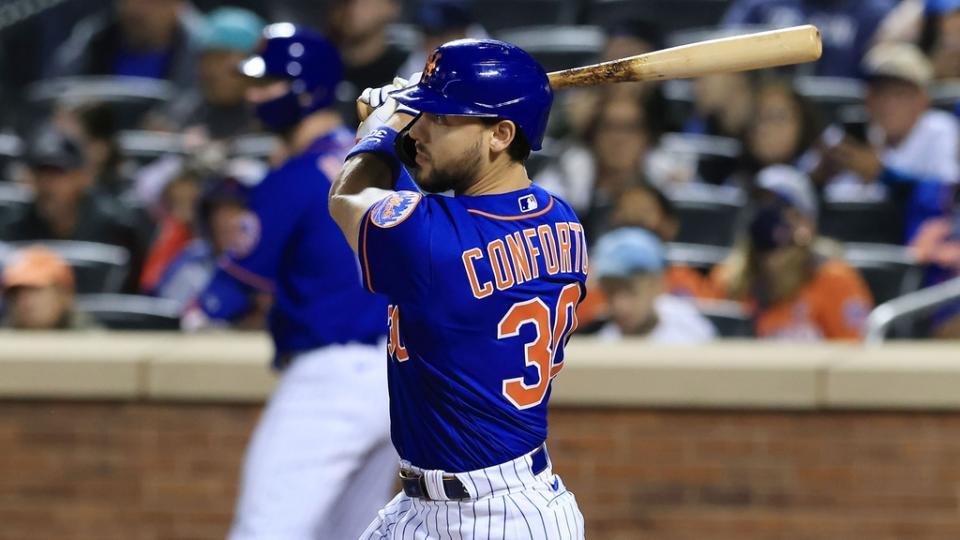 Sep 30, 2021;  New York City, New York, USA;  New York Mets right fielder Michael Conforto (30) hits an RBI single during the third inning against the Miami Marlins at Citi Field.