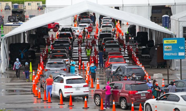 Vehicles line up at a COVID-19 drive-thru testing center on Sunday at Hard Rock Stadium in Miami Gardens, Florida.