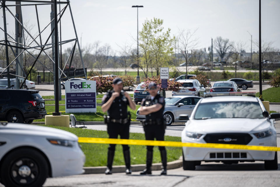 Image: Police officers stand behind caution tape near a crime scene on April 16, 2021 in Indianapolis. (Jon Cherry / Getty Images)