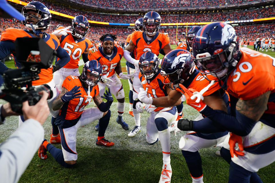 The Denver Broncos defense celebrates cornerback Pat Surtain II's, center, interception during the second half of an NFL football game against the Los Angeles Chargers, Sunday, Nov. 28, 2021, in Denver. (AP Photo/Jack Dempsey)