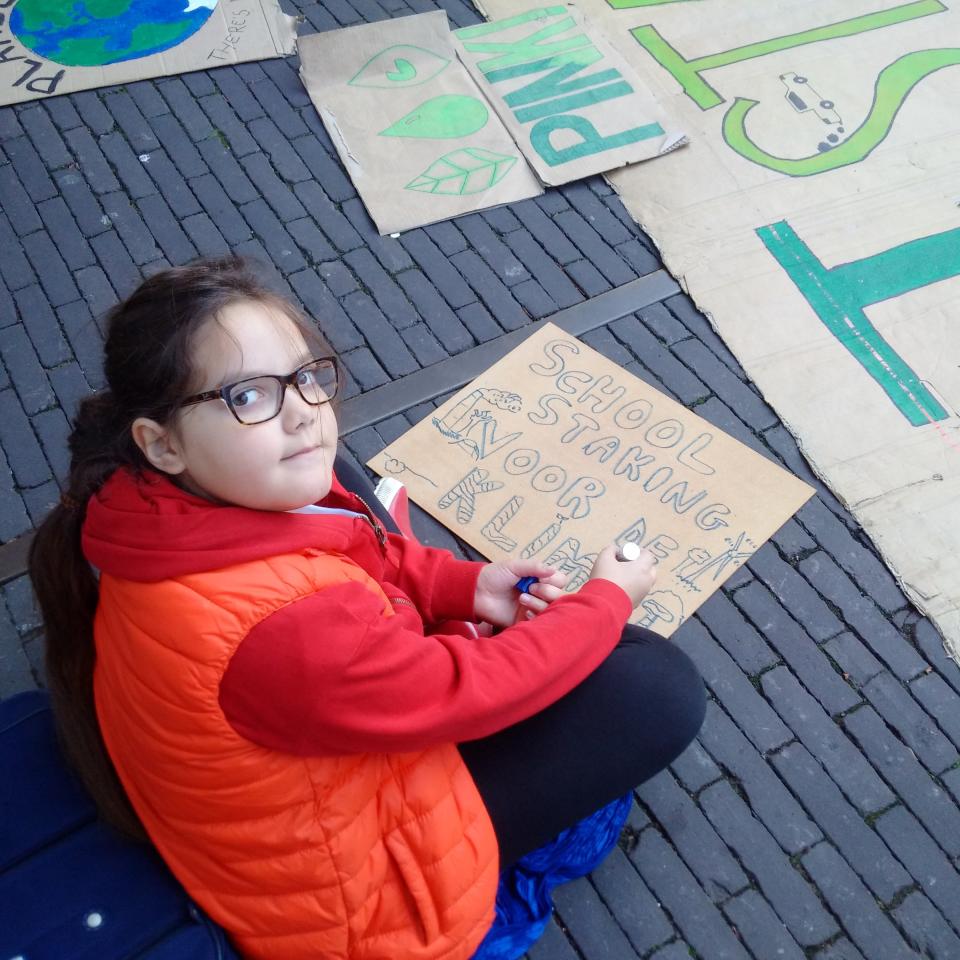 Lilly Platt making a placard reading "school strike for climate" at the Hague in the Netherlands. She ditches school every Friday to protest global inaction on climate change.&nbsp; (Photo: Eleanor Platt)