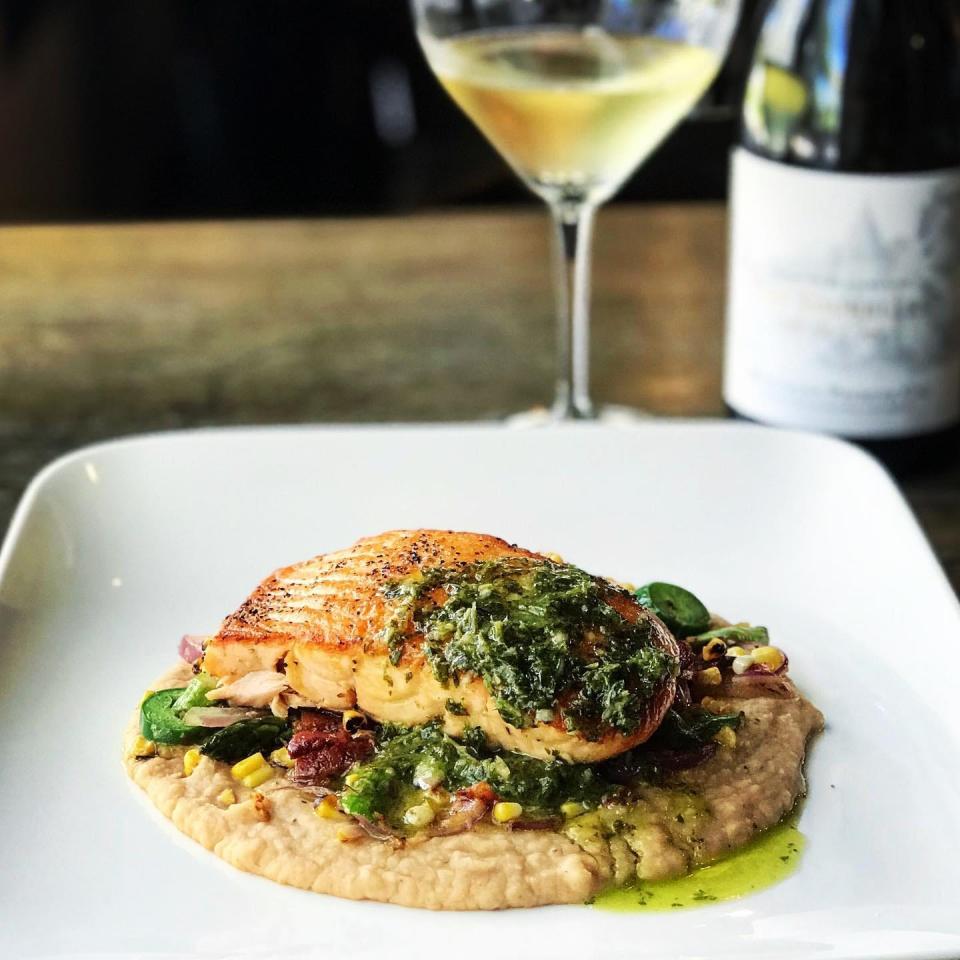 Salmon succotash, on the menu at Salute Market, features seared salmon, garlicky white bean puree, saut&#xe9;ed asparagus, bacon, roasted corn, onions and jalape&#xf1;os.