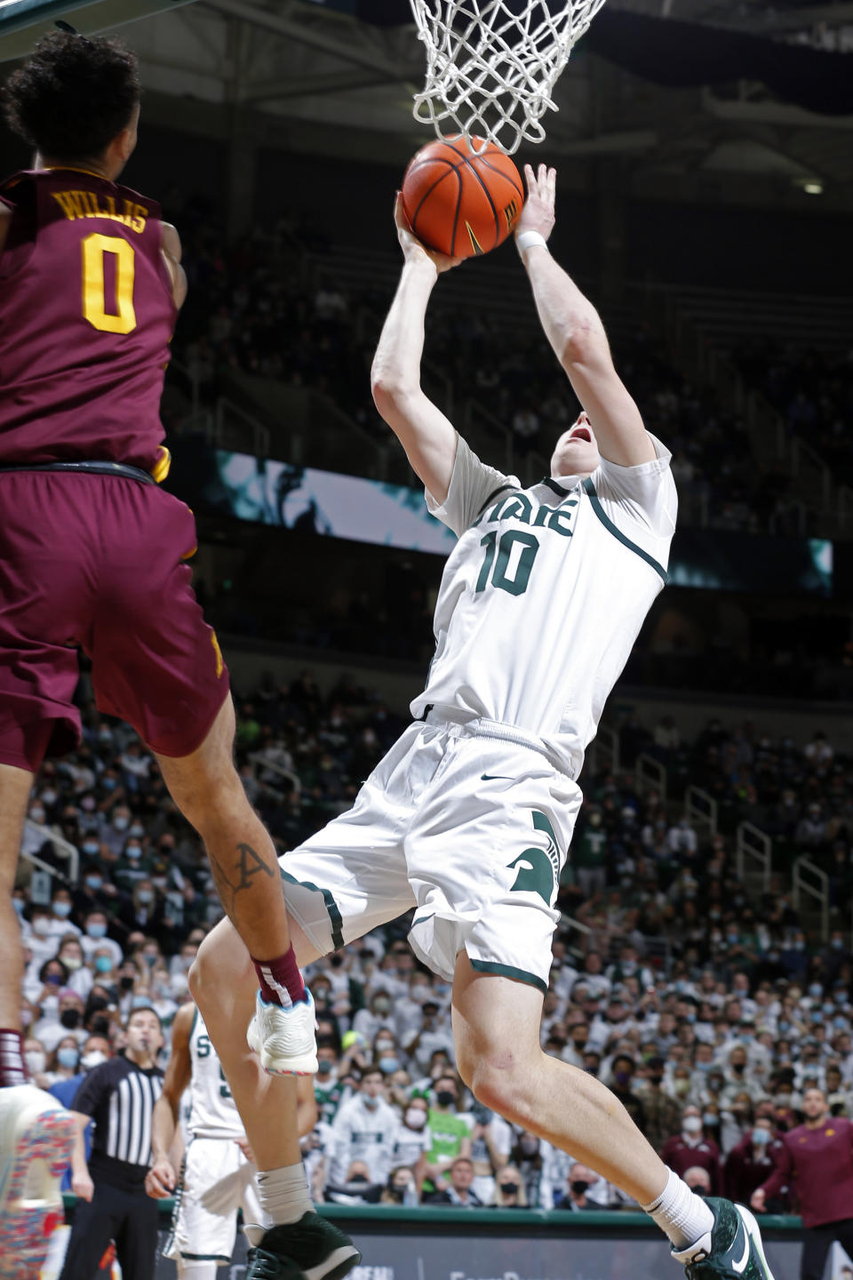 Michigan State's Joey Hauser, right, puts up the game-winning shot against Minnesota's Payton Willis (0) late in the second half of an NCAA college basketball game, Wednesday, Jan. 12, 2022, in East Lansing, Mich. Michigan State won 71-69. (AP Photo/Al Goldis)