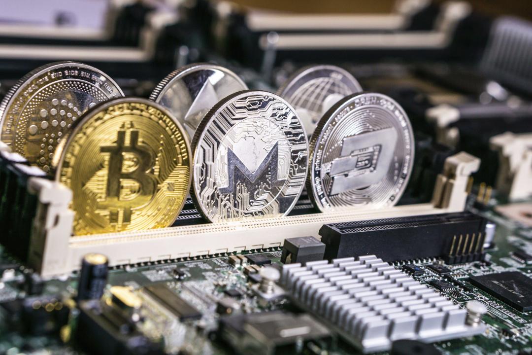 Golden Bitcoin and altcoins Monero and dash Cryptocurrency on computer circuit board. Blockchain and security concept