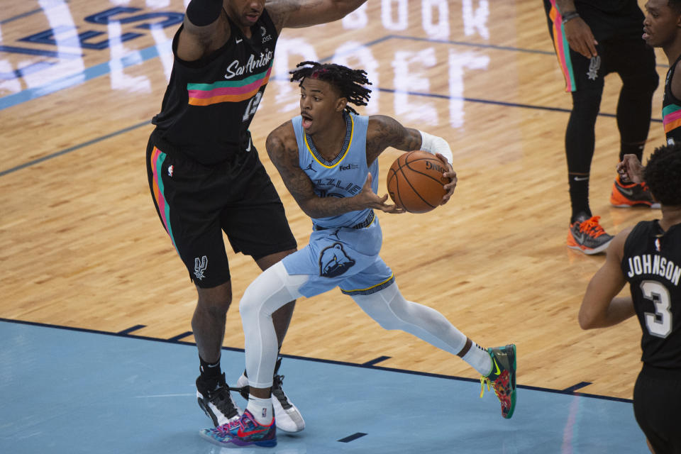 Dec 23, 2020; Memphis, Tennessee, USA; Memphis Grizzlies guard Ja Morant (12) goes to the basket against San Antonio Spurs forward LaMarcus Aldridge (12) during the first half at FedExForum. Mandatory Credit: Justin Ford-USA TODAY Sports