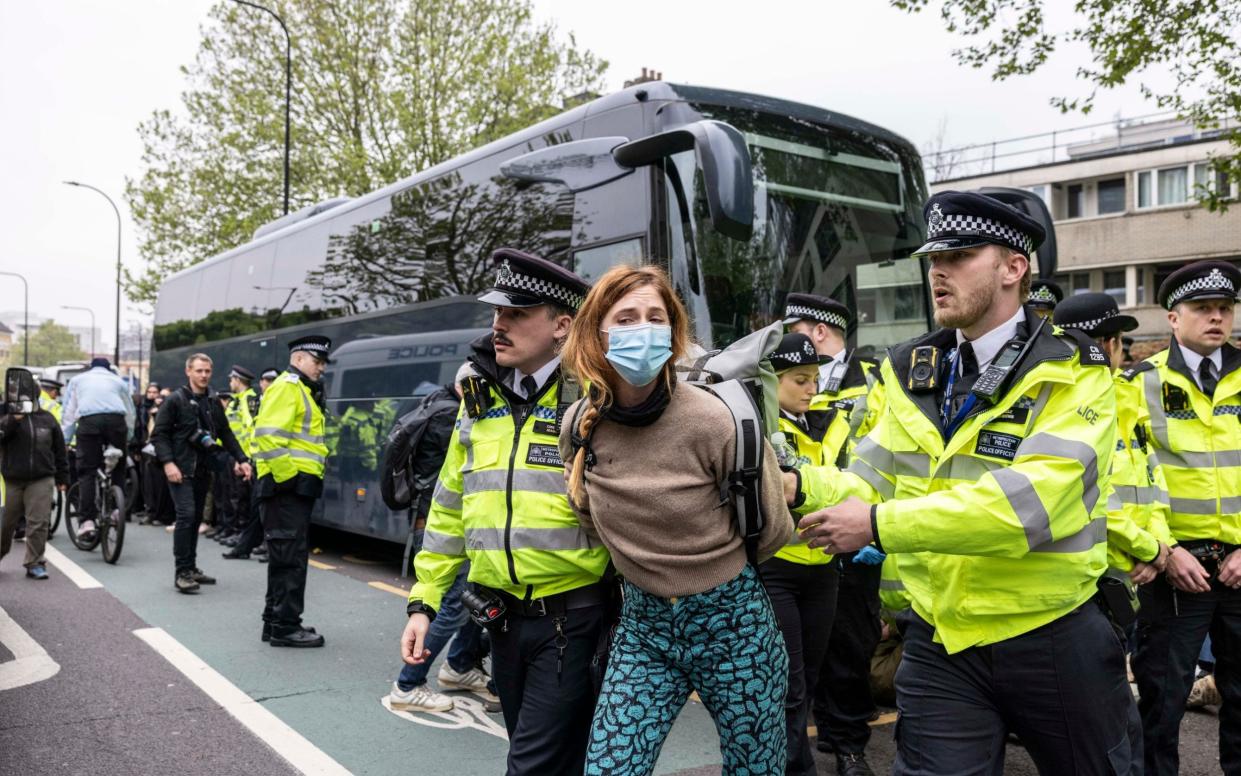 A protester is removed by police