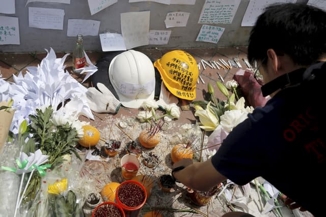 Mourners stop by a makeshift memorial