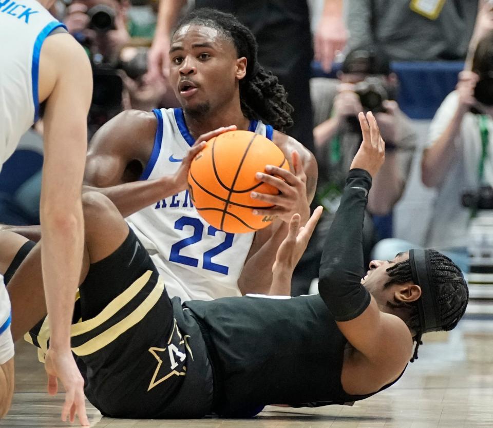 Kentucky guard Cason Wallace (22) battles Vanderbilt guard Ezra Manjon (5) for a loose ball during the first half of a quarterfinal SEC Menâ€™s Basketball Tournament game at Bridgestone Arena Friday, March 10, 2023, in Nashville, Tenn.

Sec Basketball Vanderbilt Vs Kentucky