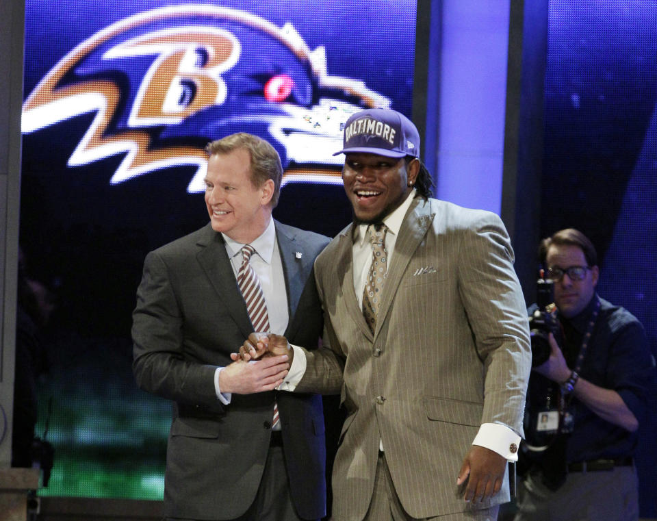 Alabama defensive end Courtney Upshaw, right, poses for photographs with NFL Commissioner Roger Goodell after being selected 35th overall by the Baltimore Ravens in the second round of the NFL football draft at Radio City Music Hall, Friday, April 27, 2012, in New York. (AP Photo/Frank Franklin II)