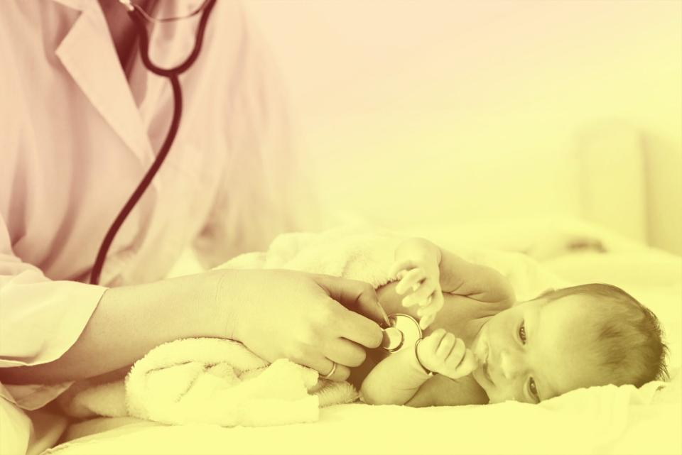 doctor examines infant with stethoscope