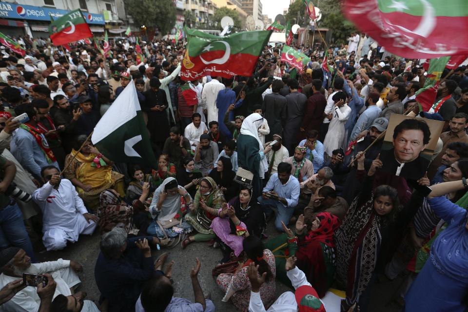 Supporters of former Prime Minister Imran Khan's party hold a protest to condemn Election Commission's decision, in Karachi, Pakistan, Friday, Oct. 21, 2022. Pakistan's elections commission on Friday disqualified former Prime Minister Imran Khan from holding public office for five years, accusing him of unlawfully selling state gifts and concealing assets, his spokesman and officials said. The move is likely to deepen lingering political turmoil in the impoverished country. (AP Photo/Fareed Khan)