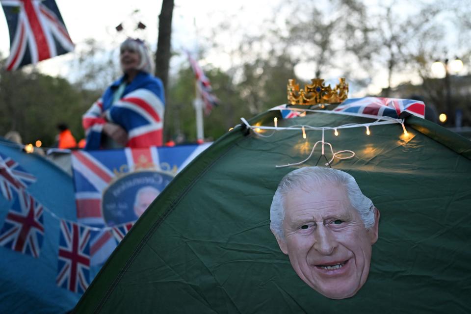 A crown sits on a tent, decorated with a portrait of Britain's King Charles III on The Mall in central London, on May 4, 2023, ahead of the coronation weekend. (Photo by SEBASTIEN BOZON / AFP) (Photo by SEBASTIEN BOZON/AFP via Getty Images)