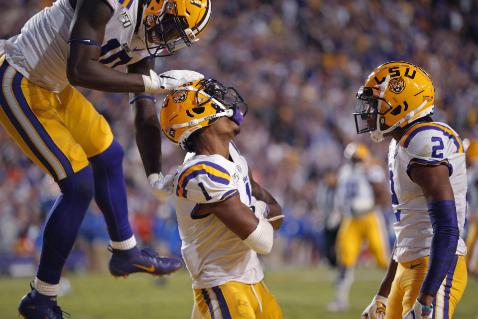 LSU wide receiver Ja'Marr Chase (1) celebrates his touchdown reception with wide receiver Josh Hammond (10) and wide receiver Justin Jefferson (2) in the second half of an NCAA college football game against Florida in Baton Rouge, La., Saturday, Oct. 12, 2019. LSU won 42-28. (AP Photo/Gerald Herbert)