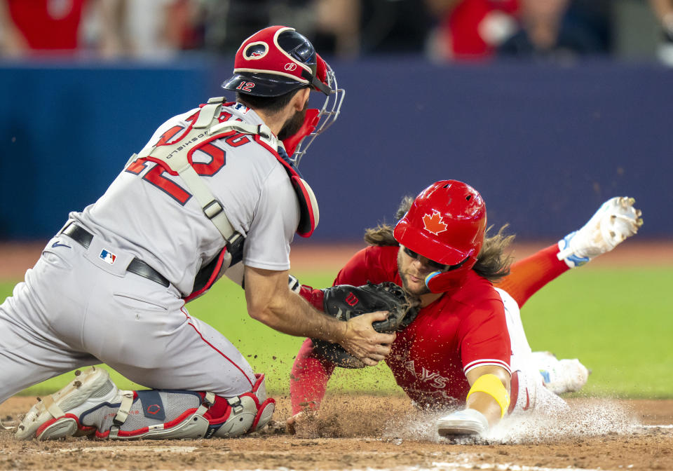 Boston Red Sox catcher Connor Wong (12) tags out Toronto Blue Jays' Bo Bichette for the final out of a baseball game Saturday, July 1, 2023, in Toronto. (Frank Gunn/The Canadian Press via AP)