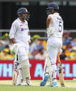 India's Shardul Thakur, left, and teammate Washington Sundar talk during play on day three of the fourth cricket test between India and Australia at the Gabba, Brisbane, Australia, Sunday, Jan. 17, 2021. (AP Photo/Tertius Pickard)