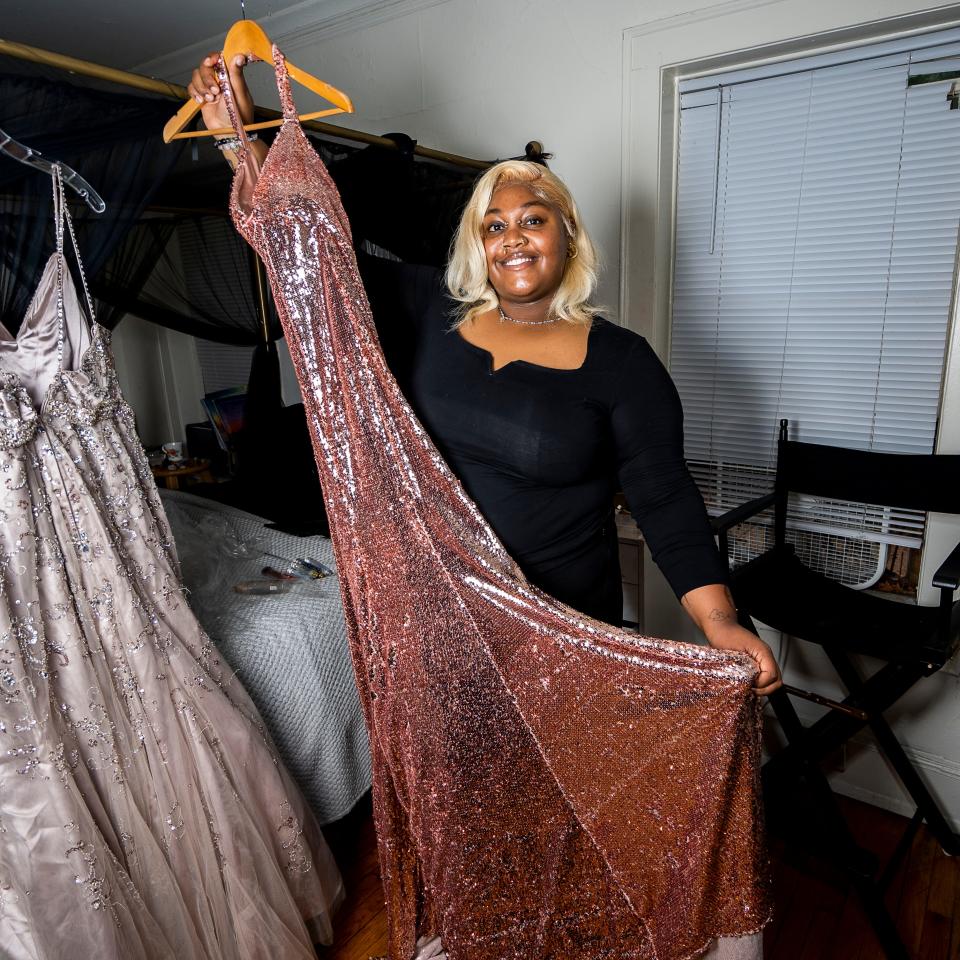 Keeping the Khemistry owner Jakayla Bridges showcases a donated prom dress, part of a nonprofit initiative which helps teens get ready for formal events, on Friday, Sept. 22, 2023, in Milwaukee, Wis.