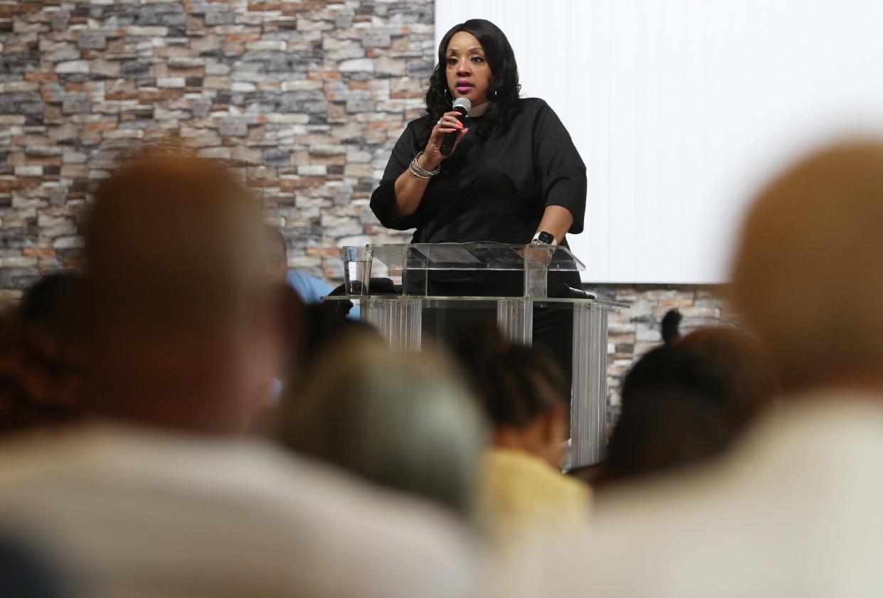 Pastor Deniela T. Williams of New Millennium House of Prayer introduces talks about the new the associate pastors before they give their initial sermons at the church in Akron.