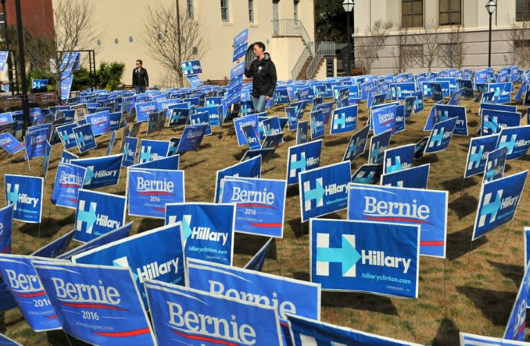 A group of signs for Democratic presidential candidates Bernie Sanders and Hillary Clinton shows a tightening nomination race before the start of the debate on January 17, 2016 in South Carolina