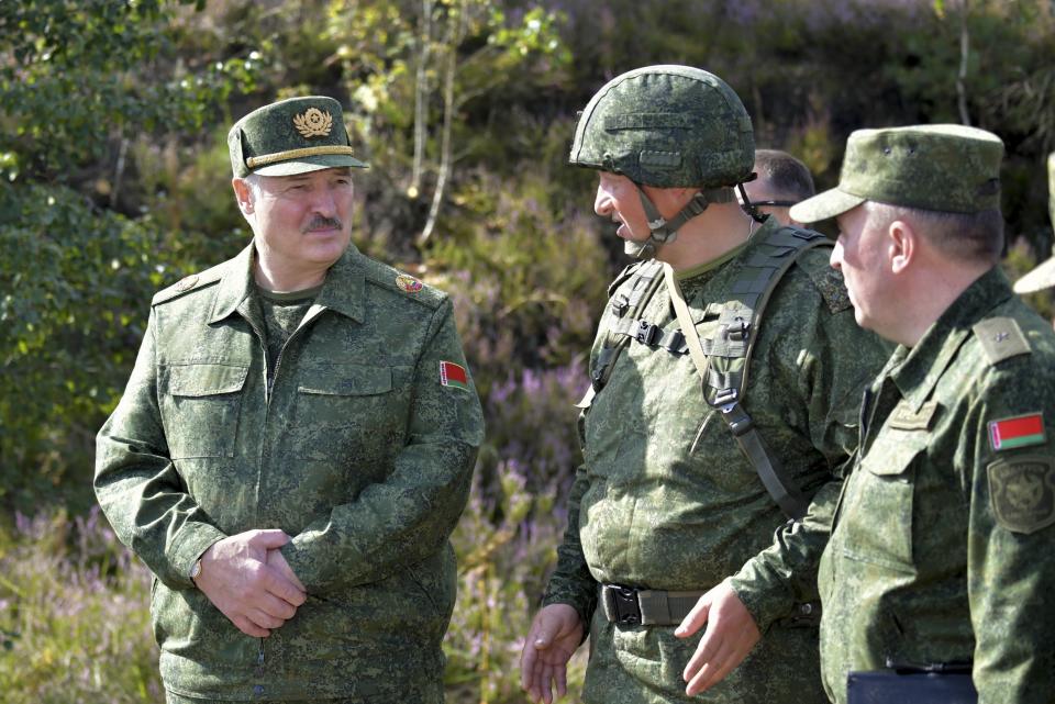 FILE - In this Aug. 22, 2020, file photo, Belarusian President Alexander Lukashenko, left, speaks to high ranking officers as he visits a military exercise near Grodno, Belarus, near the borders of Poland and Lithuania. With protests in Belarus now in their third week — including rallies that brought out an estimated 200,000 people in Minsk for the last two Sundays — Lukashenko is moving to squelch the demonstrations gradually with vague promises of reforms mixed with threats, court summonses and the selective jailing of leading activists. (Andrei Stasevich/BelTA Pool Photo via AP, File)