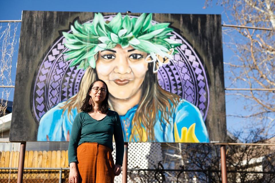 Maile Arvin, a garden volunteer and University of Utah professor, poses for a portrait in front of a mural dedicated to Margarita Satini at the Og-Woi People's Garden in Salt Lake City on April 10.