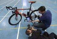 Johan Kucaba, Equipment Coordinator at UCI holds a tablet using magnetic resonance technology to detect a bike equipped with a motor during a media event at the Union Cycliste Internationale (UCI) in Aigle, Switzerland May 3, 2016. REUTERS/Denis Balibouse