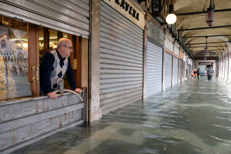 A man stands inside is store in St. Mark’s Square after days of severe flooding in Venice