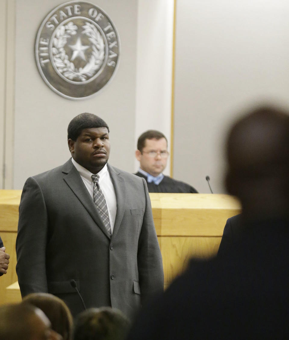 Former Dallas Cowboys' Josh Brent stands in court as potential jurors are directed into Judge Robert Burns, looking on in back, courtroom Friday, Jan. 10, 2014, in Dallas. Jury selection continues for the upcoming trial of Brent, who's accused of killing a practice squad player in a drunken-driving wreck. Opening statements in the case are expected next week. (AP Photo/LM Otero)