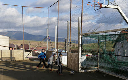 Roma children play with a ball on a playground near the so called "Sheffield Square" in the town of Bystrany, Slovakia, November 28, 2016. Picture taken November 28, 2016. REUTERS/David W Cerny