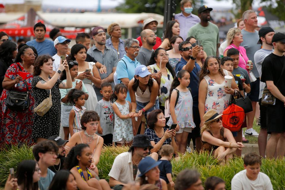 A crowd watches a fashion show during the 2022 Asian Night Market Festival featuring food, cultural demonstrations, a fashion show and more.