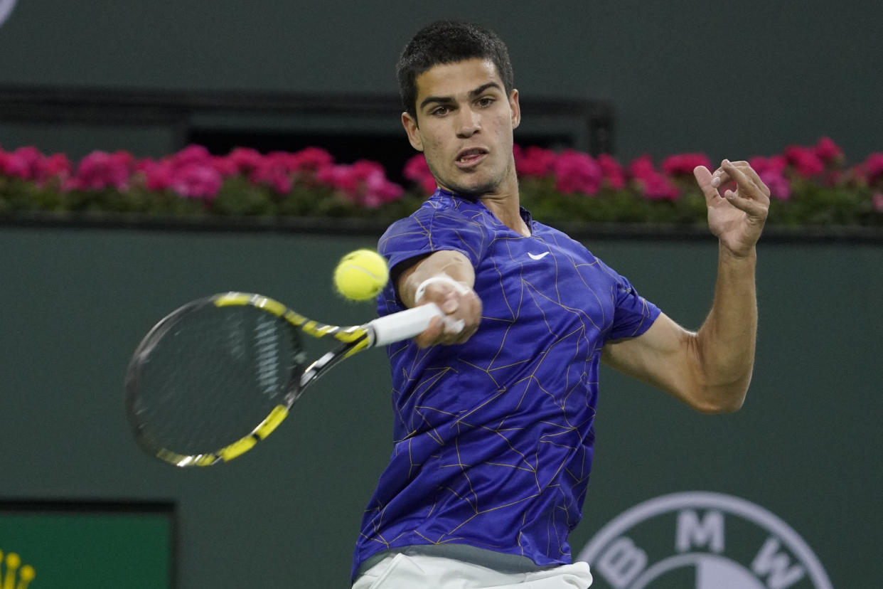 Carlos Alcaraz, of Spain, returns to Cameron Norrie, of Britain, during a quarterfinal match in the BNP Paribas Open tennis tournament Thursday, March 17, 2022, in Indian Wells, Calif. (AP Photo/Mark J. Terrill)