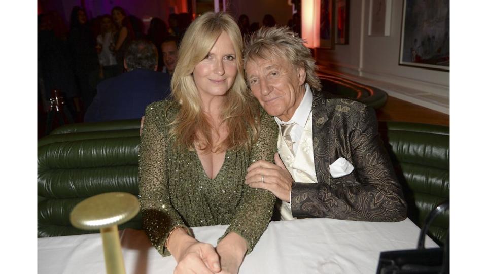 Penny Lancaster in green dress and Rod Stewart in suit