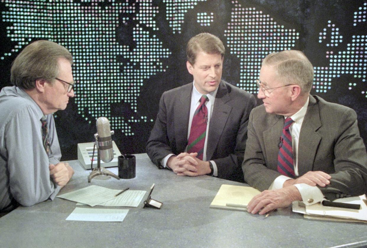 Larry King holds a debate with Al Gore and Ross Perot. 