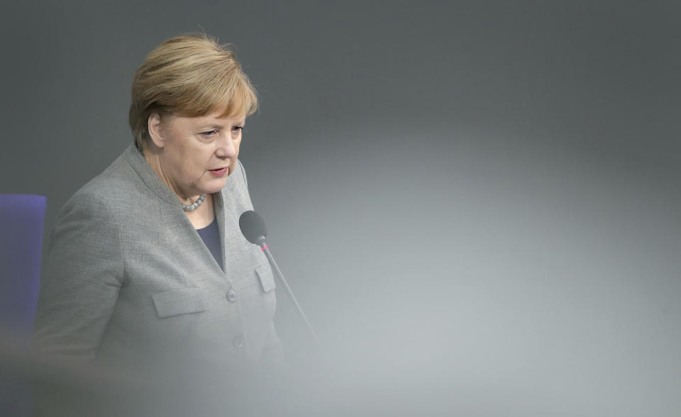 German Chancellor Angela Merkel takes questions as part of a meeting of the German parliament, Bundestag, at the Reichstag building in Berlin, Germany, Wednesday, Dec. 18, 2019. (AP Photo/Michael Sohn)