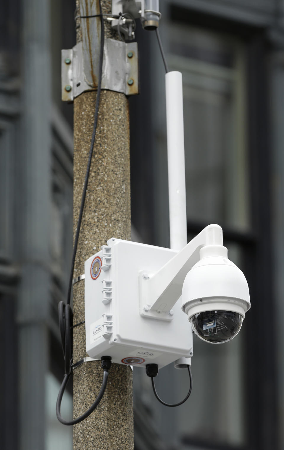 A surveillance camera is attached to a light pole along Boylston Street near the finish line of the Boston Marathon, Monday, April 14, 2014, in Boston. A year after twin pressure cooker bombs shattered the marathon and paralyzed the area for days, federal prosecutors say they have a trove of evidence ready to use against the surviving suspect, but many questions remain. (AP Photo/Steven Senne)