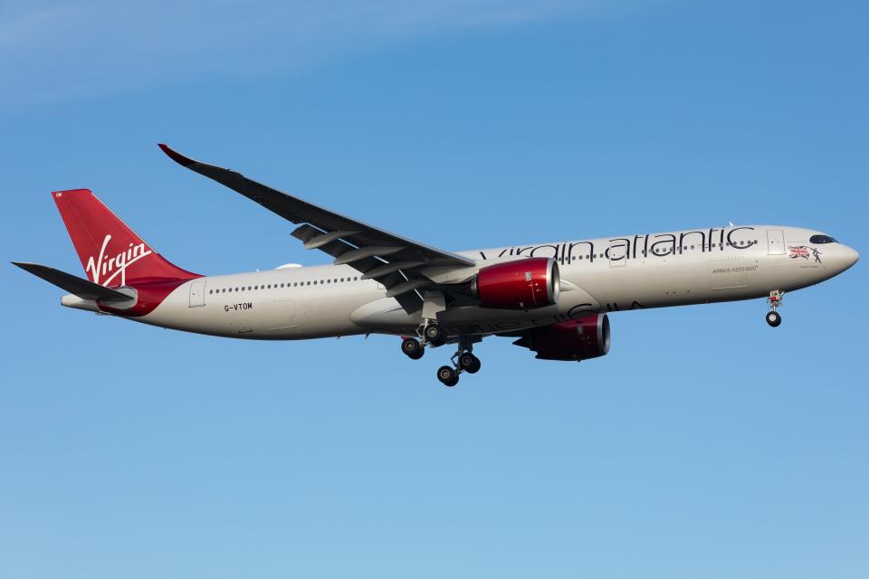 A Virgin Atlantic Airbus A330 flies through clear, blue skies.