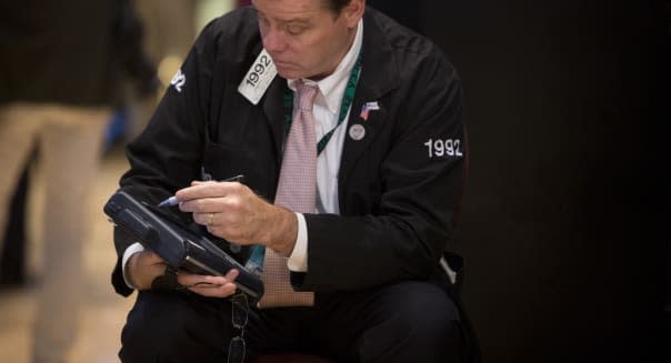 A trader works on the floor of the New York Stock Exchange (NYSE) in New York, U.S., on Wednesday, Aug. 21, 2013. U.S. stocks fell, giving the Dow Jones Industrial Average its longest slump in 13 months, as minutes of the Federal Reserve's July meeting showed officials support stimulus cuts this year if the economy improves. Photographer: Scott Eells/Bloomberg via Getty Images