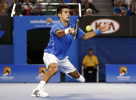 Novak Djokovic of Serbia hits a return against Milos Raonic of Canada during their men's singles quarter-final match at the Australian Open 2015 tennis tournament in Melbourne January 28, 2015. REUTERS/Thomas Peter