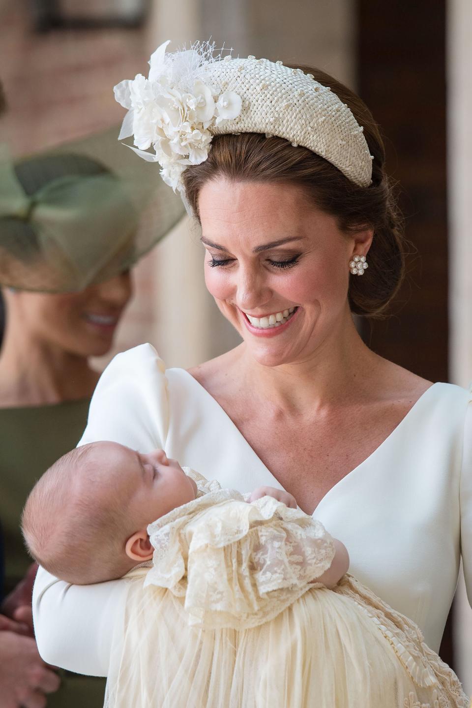 Kate began her headband trend at the July 2018 <a href="https://people.com/royals/kate-middleton-prince-louis-royal-christening/" rel="nofollow noopener" target="_blank" data-ylk="slk:christening of son Prince Louis;elm:context_link;itc:0;sec:content-canvas" class="link ">christening of son Prince Louis</a>. For the occasion, she wore an Alexander McQueen dress with a structured shoulder detail and a dramatic Jane Taylor headpiece adorned with floral details fit for a princess.