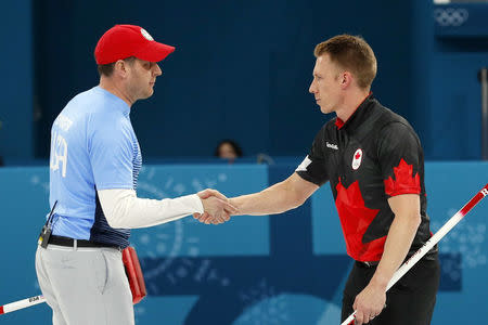 Curling - Pyeongchang 2018 Winter Olympics - Men's Semi-final - Canada v U.S. - Gangneung Curling Center - Gangneung, South Korea - February 22, 2018 - Skip John Shuster of the U.S. and vice-skip Marc Kennedy of Canada shake hands after the game. REUTERS/Phil Noble