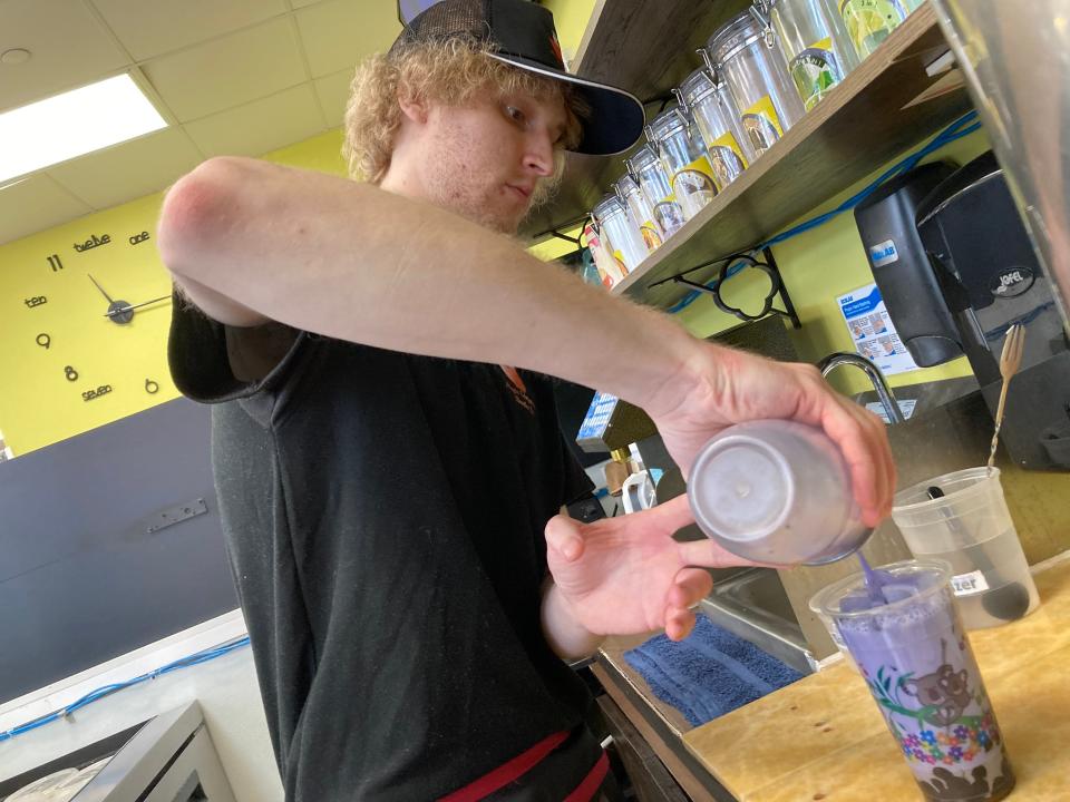 Jon Berke pours taro bubble milk tea Nov. 1, 2023 at Magic Chopsticks Noodle Bar in Burlington.