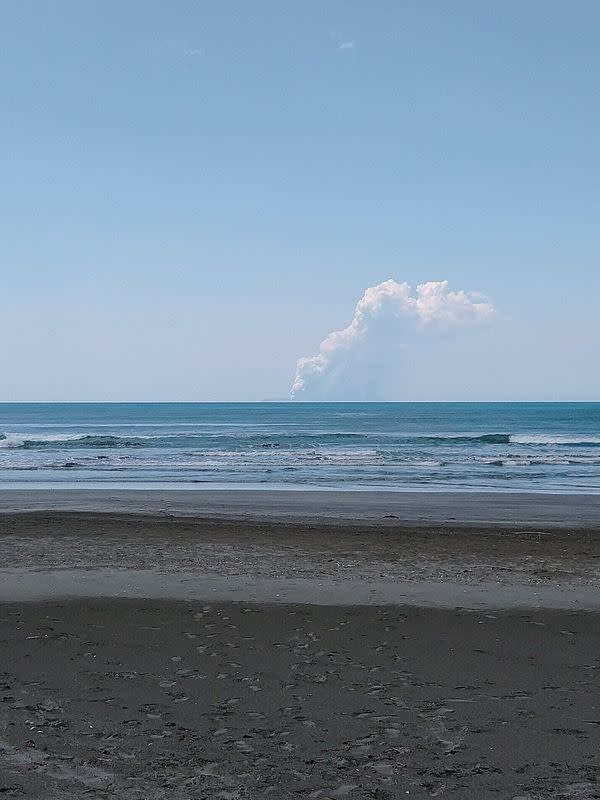 Smoke bellows from Whakaari, also known as White Island, volcano as it erupts, as seen from a distance at Ohope beach