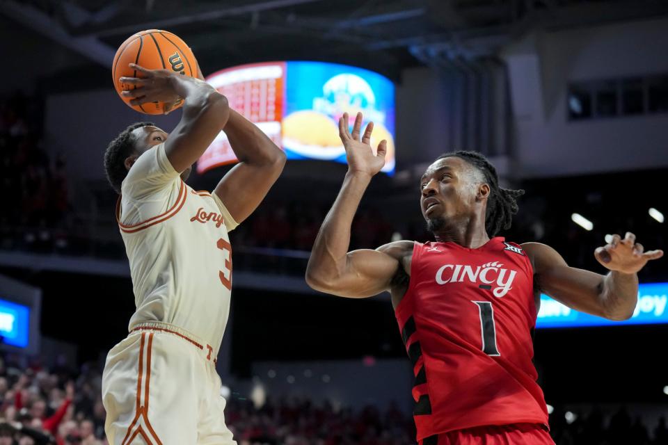 Texas guard Max Abmas shoots the winning shot over Cincinnati guard Day Day Thomas in Texas' 74-73 win Tuesday night in Cincinnati. With the win, Texas evened its Big 12 record at 1-1.