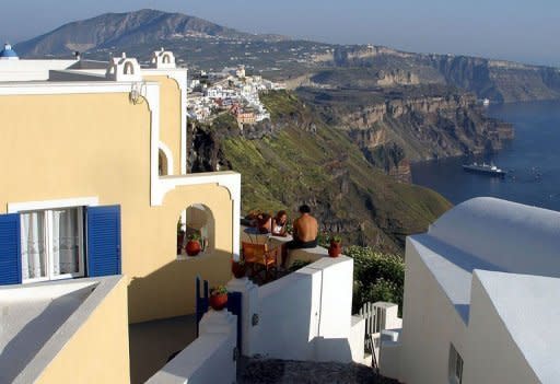 This undated photo shows tourists at the island of Santorini. The enduring boom is built on money spent by thousands of travellers who flock to Santorini by cruise ship, ferry and plane each day, drawn by the island's whitewashed villages, volcanic beaches and jaw-dropping sunset vistas