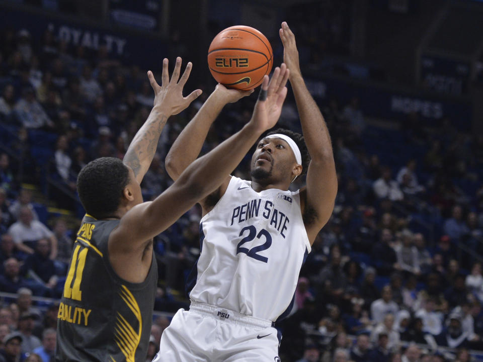 Penn State's Jalen Pickett (22) shoots over Iowa's Tony Perkins (11) during the first half of an NCAA college basketball game, Sunday, Jan. 1, 2023, in State College, Pa. (AP Photo/Gary M. Baranec)