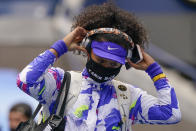 Naomi Osaka, of Japan, pulls off her headphones as she walks on the court before playing against Victoria Azarenka, of Belarus, in the women's singles final of the US Open tennis championships, Saturday, Sept. 12, 2020, in New York. (AP Photo/Seth Wenig)